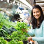 31375074 – young woman choosing leafy vegetables