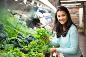 31375074 - young woman choosing leafy vegetables