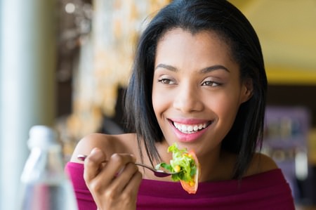 45334789 - woman eating fresh salad