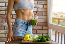 Fit woman drinking Green smoothie.