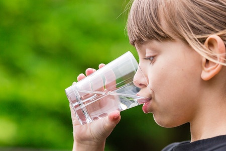 45705559 - young girl drinking tap water